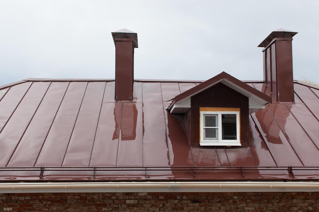 red roof with two chimneys