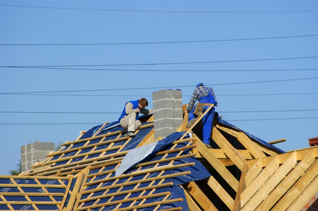 men working with the house roof