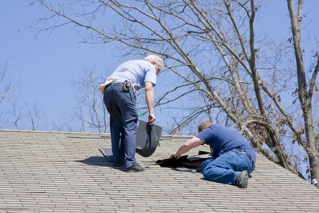 men working on the house roof